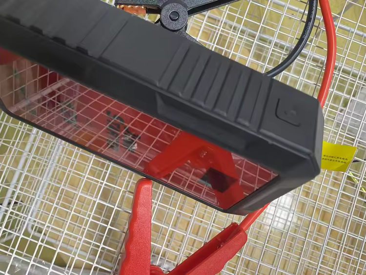 Buyer photo of the jump starter with its red and black clamps