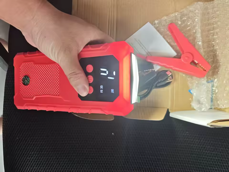 Buyer photo of the jump starter fresh out of the box with its clamps